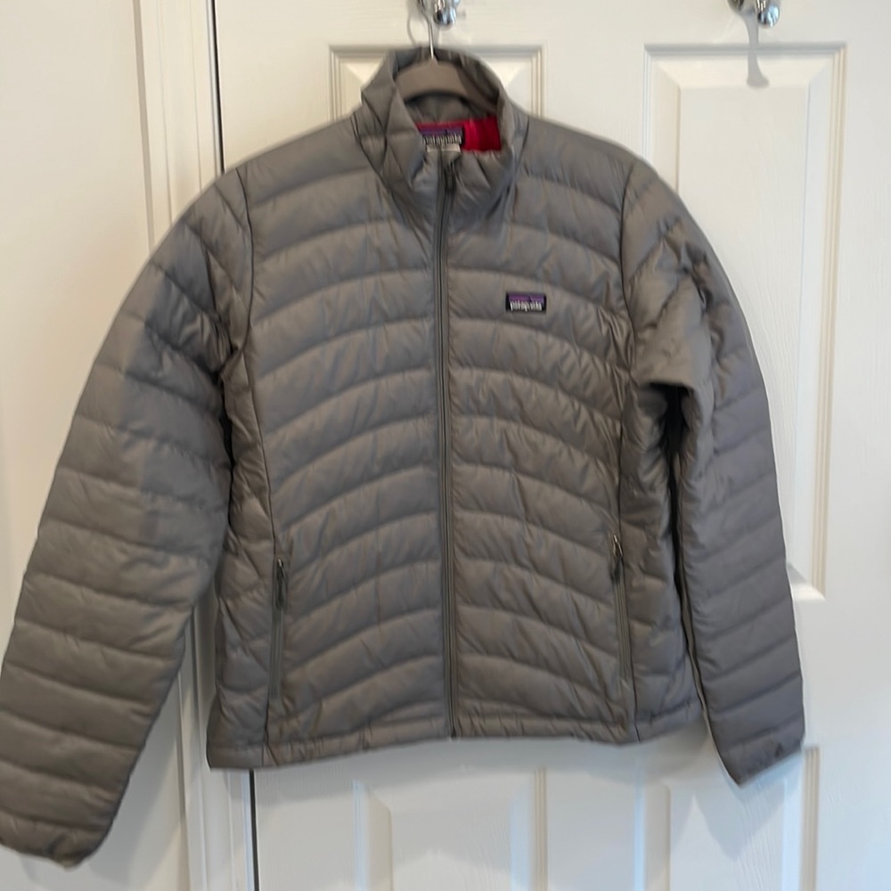 Brand new Patagonia jacket. Grey exterior with beautiful pink interior.